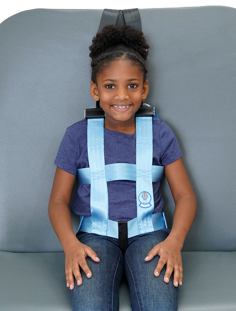 Child wearing safety vest sitting on bus seat