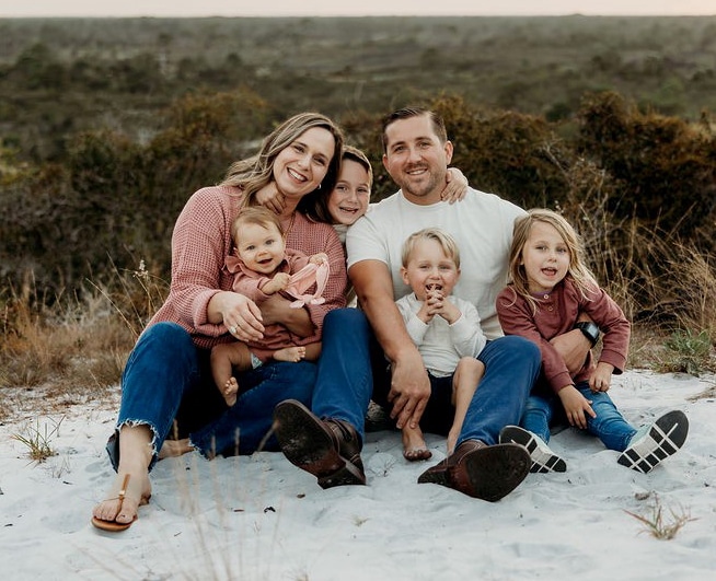 Wollak Family sitting on a beach